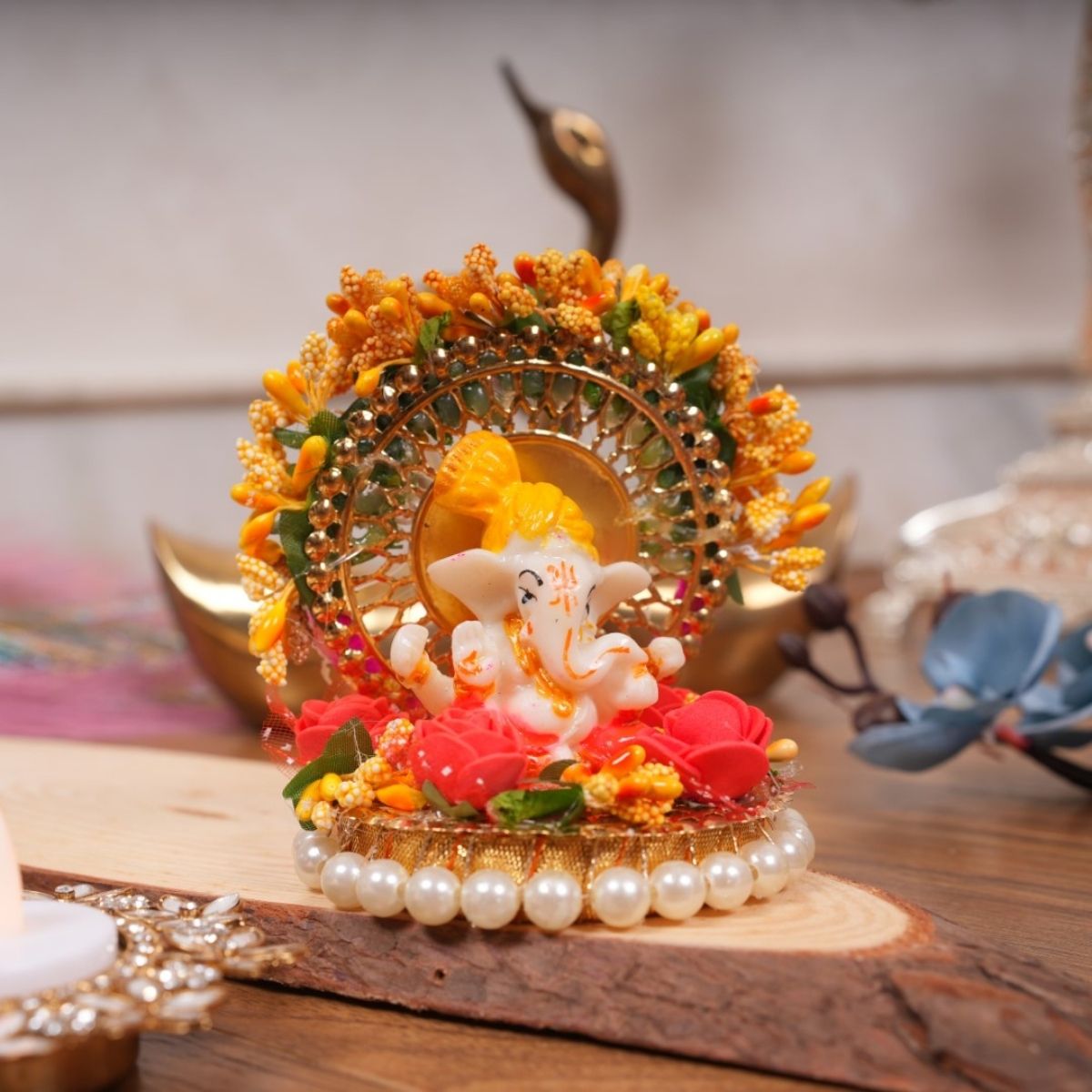 Tiny Shiny Lord Ganesha Idol with Golden Circular Arch and Pearl Bead Plate
